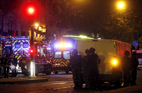 French riot police secure the area near the Bataclan concert hall following a fatal shooting at a restaurant in Paris, France, November 13, 2015. At least 30 people were killed in attacks in Paris and a hostage situation was under way at a concert hall in the French capital, French media reported on Friday.  REUTERS/Christian Hartmann