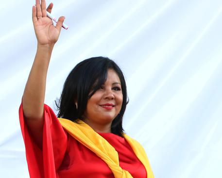 In this Friday, Jan. 1, 2016 photo, Gisela Mota waves during her swearing in ceremony as mayor of Temixco, Morelos State, Mexico. The Morelos state Public Security Commission says attackers invaded Mota's house on Saturday morning and killed her. (ANSA/AP Photo/Tony Rivera)