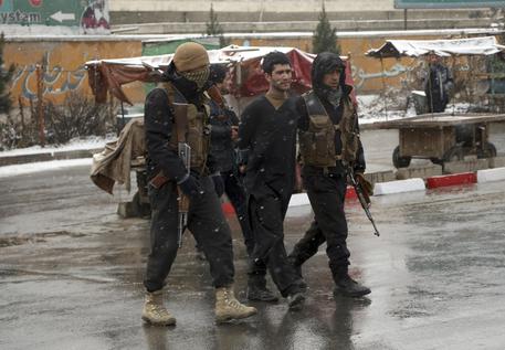 Afghan security personnel detain a suspect at the site of an attack on the Marshal Fahim military academy in Kabul, Afghanistan, Monday, Jan. 29, 2018. Militants attacked an Afghan army unit guarding the military academy on Monday, officials said. Hours later, the Islamic State group claimed responsibility for the assault. (ANSA/AP Photo/Rahmat Gul) [CopyrightNotice: Copyright 2018 The Associated Press. All rights reserved.]