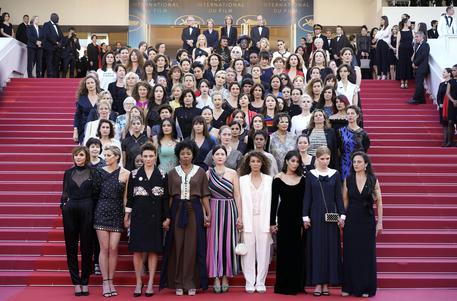 epa06731181 Actresses and female directors stand on the steps of the red carpet in protest of the lack of female filmmakers honored throughout the history of the festival at the screening of 'Girls of the Sun (Les Filles du Soleil)' during the 71st annual Cannes Film Festival, in Cannes, France, 12 May 2018.  EPA/FRANCK ROBICHON