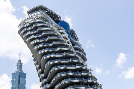 epa06934374 An exterior view of Zhu Tao Yin, nicknamed the 'twisted building' or 'forest in the air' condominium in Tapei, Taiwan, 08 August 2018. The Zhu Tao Yin, a 21-story luxury apartment building twists to allow all apartments get sunshine on every level and will be home to more than 25,000 plants. Construction on the building began in September 2013 and is scheduled to be completed in late 2018. There are two apartments on every floor, each selling for approximately one billion Taiwan dollar (30 million US dollar), making it one of the most expensive apartments people can purchase in the Asia-Pacific.  EPA/RITCHIE B. TONGO