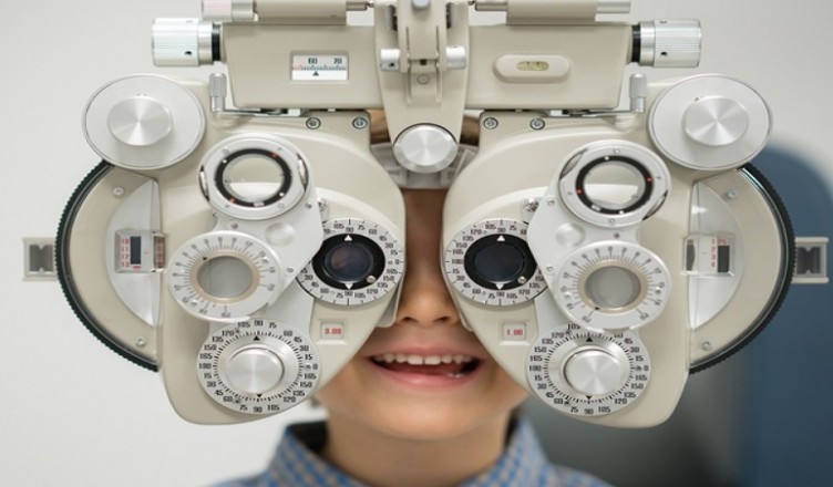 Young patient getting an eye exam at the optician