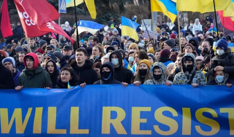 Ukrainians attend a rally in central Kyiv, Ukraine, Saturday, Feb. 12, 2022, during a protest against the potential escalation of the tension between Russia and Ukraine. Russian President Vladimir Putin and U.S. President Joe Biden are to hold a high-stakes telephone call on Saturday as tensions over a possibility imminent invasion of Ukraine escalated sharply and the U.S. announced plans to evacuate its embassy in the Ukrainian capital. (AP Photo/Efrem Lukatsky)